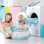 Children,in,laundry,room,with,washing,machine,or,tumble,dryer.